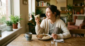 Woman enjoying a relaxed, balanced meal at home as part of a sustainable eating routine