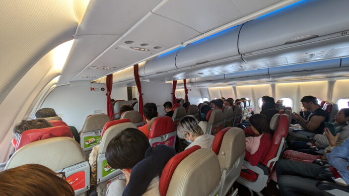 Air Asia flight boarding with passengers in the airport – Air Asia brand review.