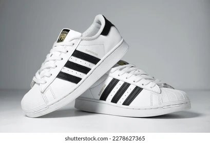 Close-up of Adidas logo on a stylish sneaker, representing sports and fashion.