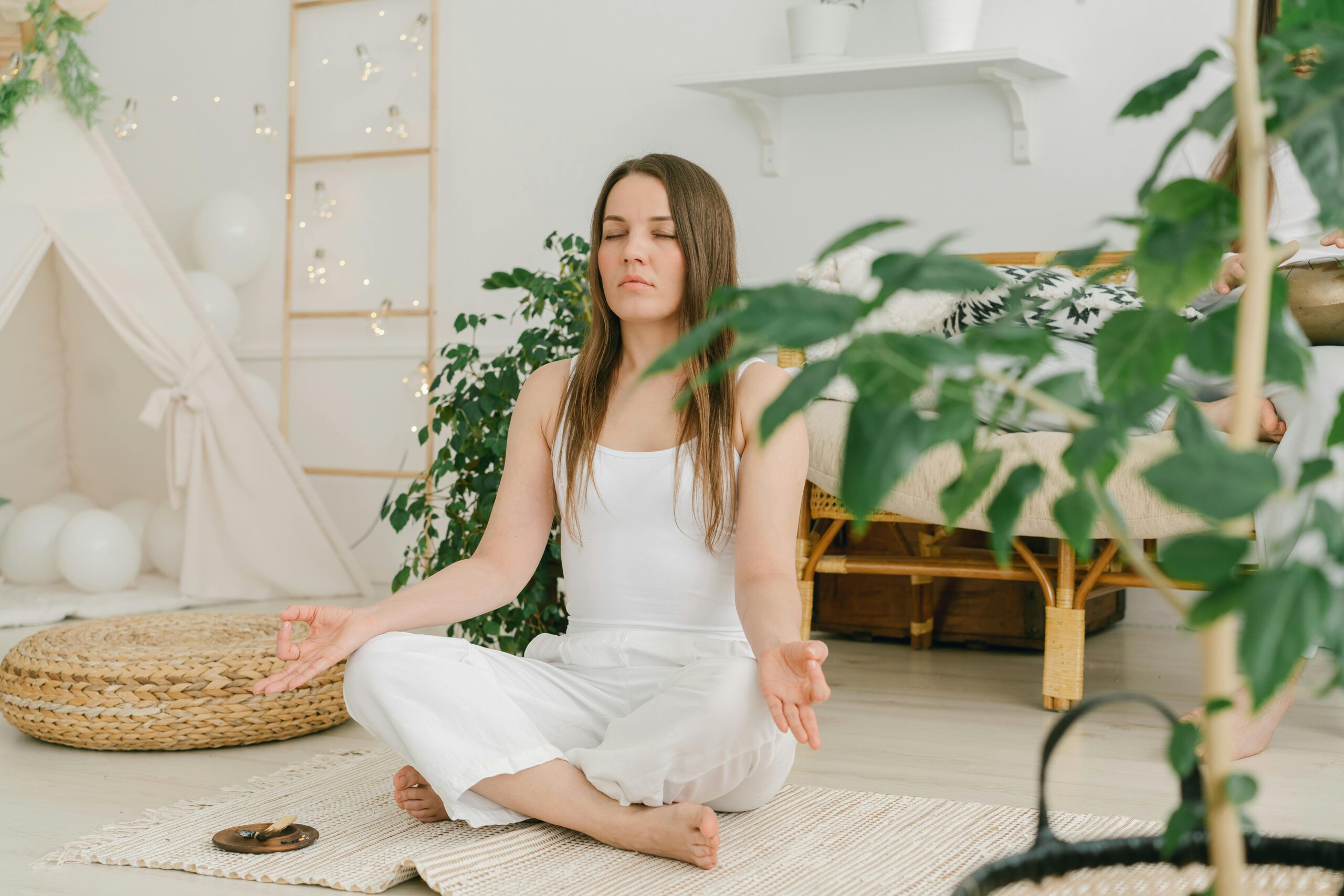 Wellness: A serene woman meditating outdoors, surrounded by nature, symbolizing holistic wellness in 2025.