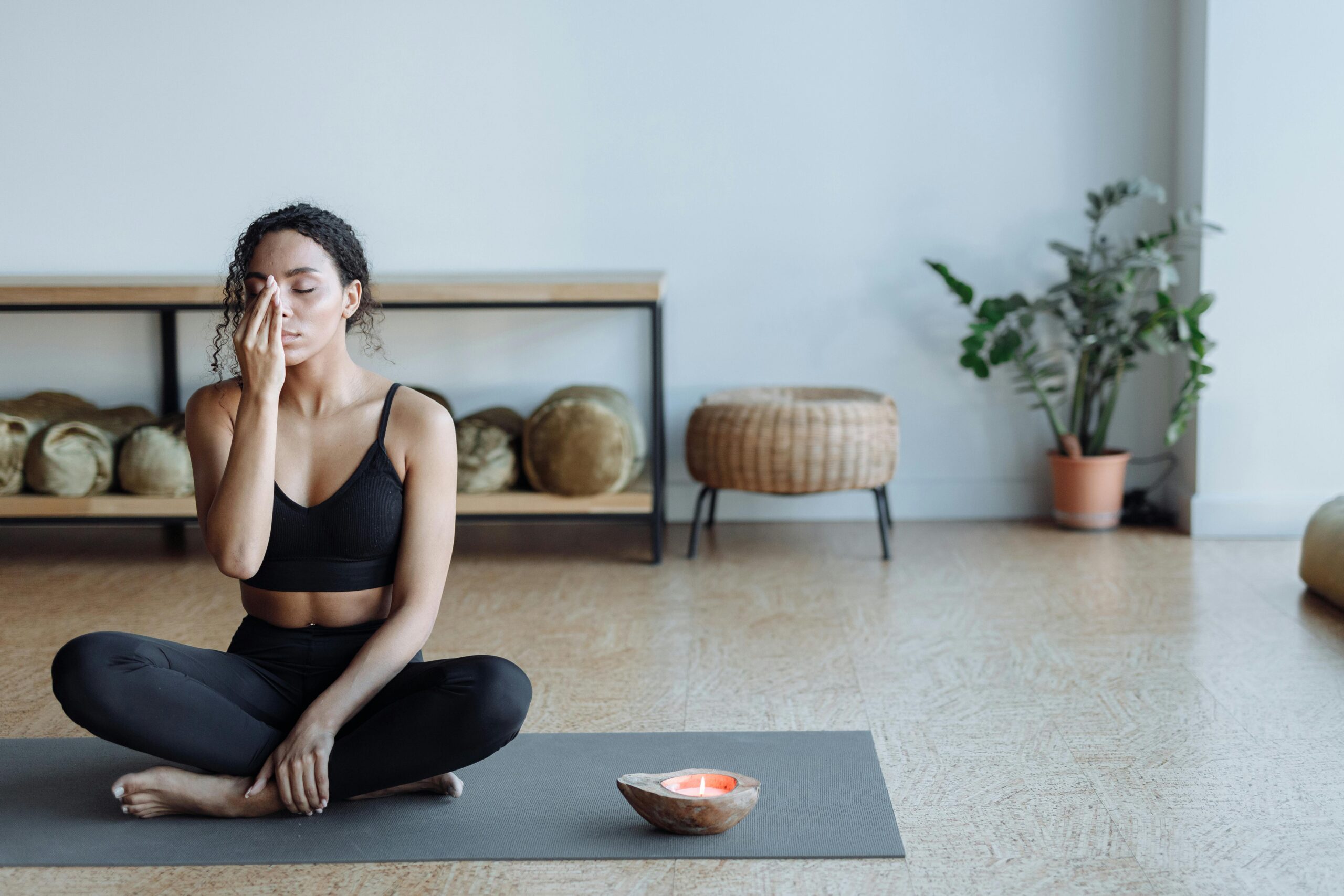 A person practicing yoga on a mat in a serene, peaceful environment for self-care.