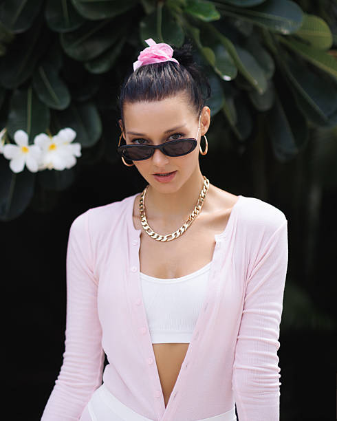 "A stylish pair of sunglasses combining a modern cat-eye shape with a retro 1990s oval frame design."